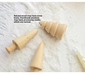 Macro shot of handcrafted natural wood cone-shaped Christmas trees with visible wood grain