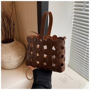 Close-up of retro dark brown hollow woven tote bag with a white inner lining