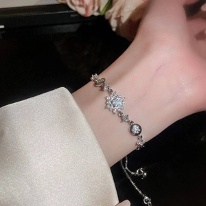 Close-up of sparkling zircon flower bracelet on wrist with elegant silver finish