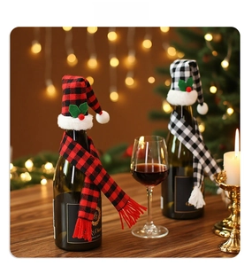 Close-up of checkered Christmas wine bottle set with scarves and hats on festive table