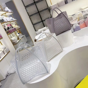 Detail of hollow lattice pattern on jelly handbags in grey purple and white colors