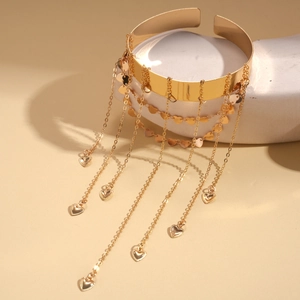 Golden metal upper arm cuff bracelet featuring multi-layer heart tassel chains