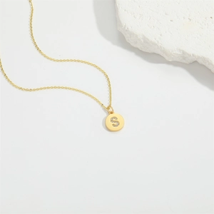 Minimalist gold necklace with a round S-letter pendant inlaid with cubic zirconia