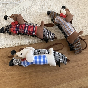 Detailed close-up of cute fabric dachshund hair clips in three plaid color patterns