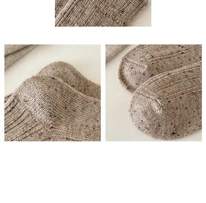 Detail shot of chunky knit texture and speckled patterns on thick thermal wool socks