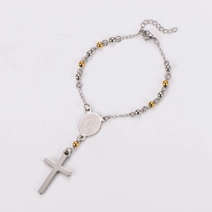 Detail of beaded religious bracelet with Virgin Mary medal and silver cross pendant