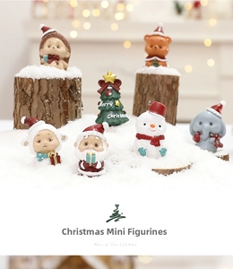 Close-up of 7 mini resin Christmas figurines featuring Santa, snowman, and animals in snow