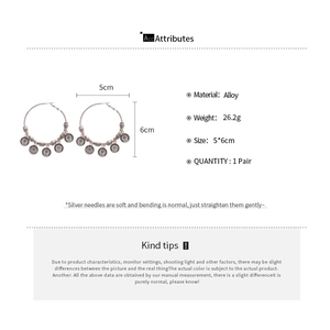 Detail view of retro geometric round earrings with five hanging coin charms on alloy hoops