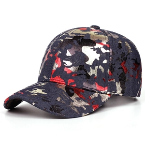 Detailed view of camouflage baseball cap with gold and silver metallic ink splatters