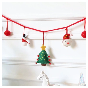 Detail of wool felt Christmas garland featuring Santa, snowman, and tree ornaments