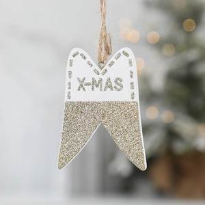 Christmas tree hanging tooth pendant with gold glitter and X-MAS lettering on white wood