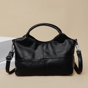 Large black soft leather tote bag with stitch details and top handles on a clean background