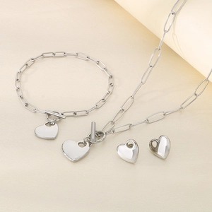 Detailed view of silver heart-shaped jewelry set with necklace bracelet and earrings