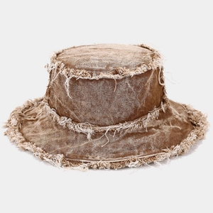 Detail of frayed edges and washed texture on a vintage tan denim bucket hat
