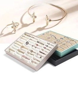 Detailed view of multi-slot velvet jewelry trays for organizing bracelets and bangles