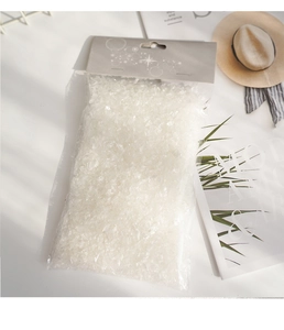 Macro detail of artificial white snow flakes in clear plastic bag for Christmas decor