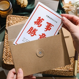 Minimalist kraft paper envelope set with festive greeting card and red wax seal accents