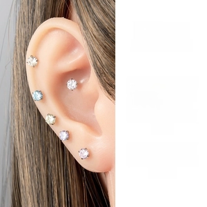 Macro shot of 4mm candy-colored cubic zirconia stud earrings set in silver prongs