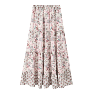 Detail of bohemian tiered maxi skirt with colorful paisley print and elastic high waist