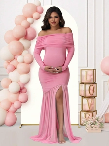 Pink off-shoulder maternity dress with mesh sleeves and side slit shown in a studio