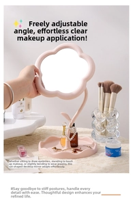 Pink floral tabletop vanity mirror with a petal frame and integrated jewelry storage base
