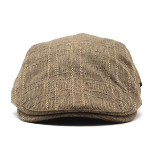 Detailed view of the woven brown plaid texture on a cotton linen flat ivy cap