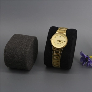 Detail of a gold stainless steel watch with calendar display on a black display pillow