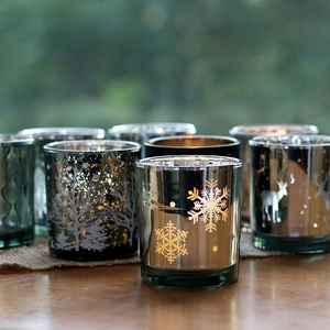 Silver electroplated glass candle holders with reindeer and snowflake patterns