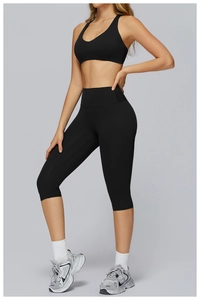 Slim fit black high waist yoga leggings and sports vest set on model for fitness