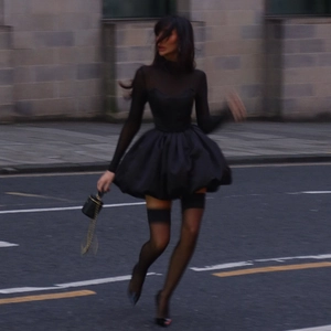 Elegant slim fit black mesh dress with bubble hem and street style urban background