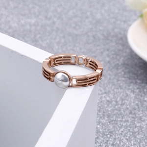Minimalist rose gold stainless steel hollow ring with elegant pearl on white block