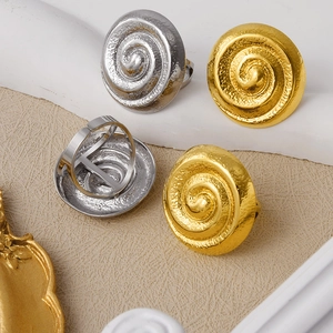 Detailed view of textured spiral stainless steel rings with adjustable open band design