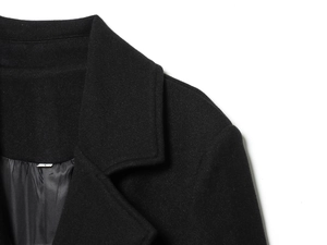Detail of wool blend coat collar showing fine texture and smooth inner lining