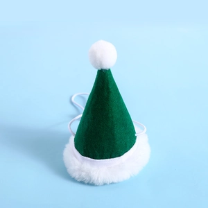 Close-up of green felt pet Christmas hat with white faux fur trim and adjustable strap