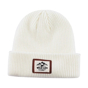 Klassische cremeweiße gerippte Strickmütze mit einem Vintage Outdoor Stickaufnäher
