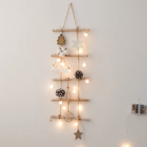 Rustic wooden Christmas tree wall hanging with warm LED lights and pinecone ornaments