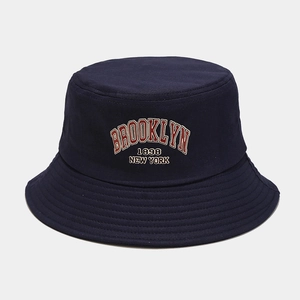 Detailed view of red Brooklyn 1898 embroidery on a navy cotton canvas bucket hat