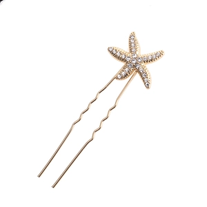 Golden starfish hair pin with sparkling rhinestones for women on white background