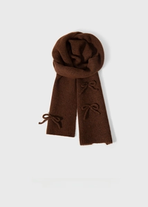 Close-up of deep brown knitted scarf with three 3D bow ties showing fabric texture