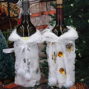 White faux fur Christmas wine bottle covers with gold and silver snowflake patterns