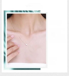 Detail of S925 sterling silver star pendant necklace worn on a female neck for a delicate look