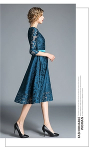 Detail of blue lace embroidered midi dress with elegant satin waist belt and A-line silhouette