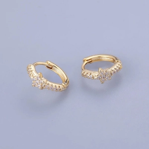 Close-up of golden star hoop earrings with micro-paved cubic zirconia and snap closure