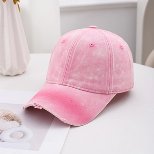 Pink distressed washed cotton baseball cap with vintage faded finish and ripped details