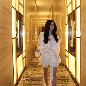 Elegant white puff sleeve mini dress with ruffle details and a shimmering finish