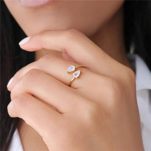 Close-up of a gold water-drop zircon ring on a finger showing elegant jewelry details