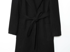 Close-up of the black wool blend coat showing fabric texture and matching waist tie detail