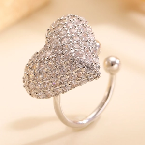 Macro shot of silver zircon heart ring with adjustable band and sparkling pavé stones