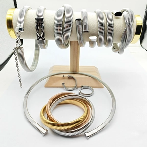 Detailed set of silver and gold tubogas style stainless steel necklace, bracelet and earrings