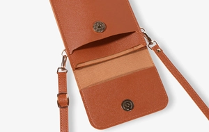 Detail of brown lychee-patterned mini crossbody bag with magnetic snap and interior pocket